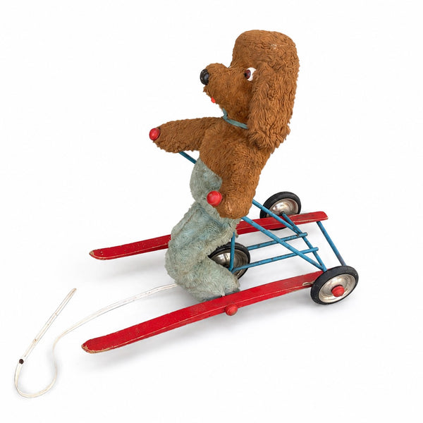 Jouet ancien à tirer animé – chien en peluche sur tricycle à skis