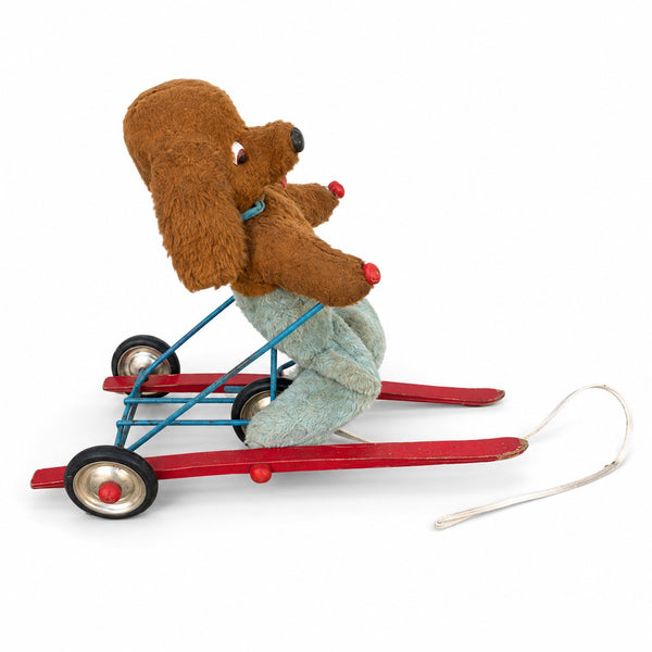 Jouet ancien à tirer animé – chien en peluche sur tricycle à skis