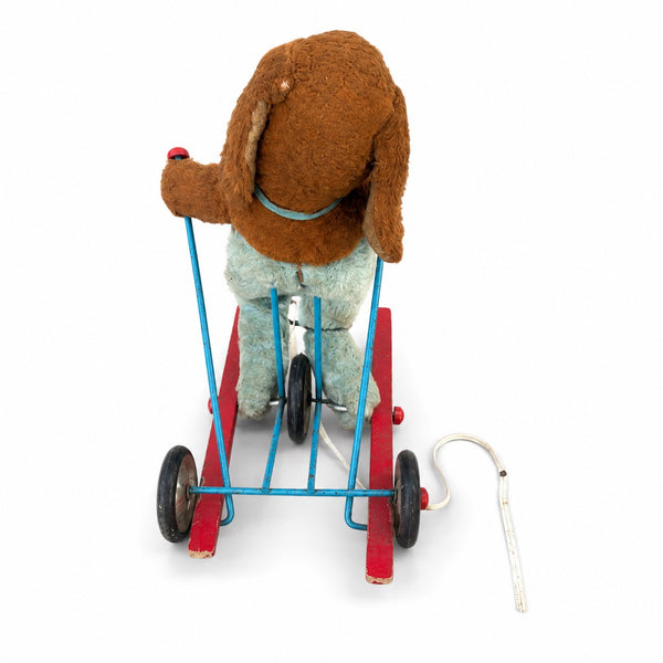 Jouet ancien à tirer animé – chien en peluche sur tricycle à skis