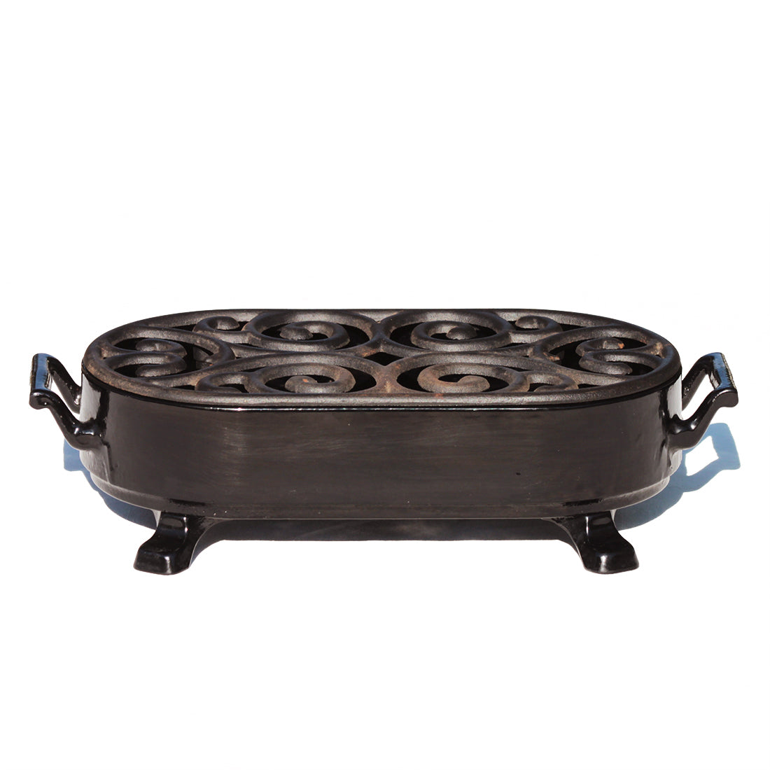 Chauffe plat vintage Staub en fonte émaillée noire à bougie