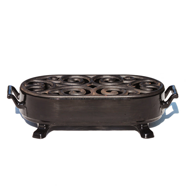 Chauffe plat vintage Staub en fonte émaillée noire à bougie