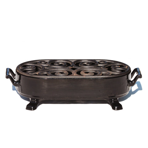 Chauffe plat vintage Staub en fonte émaillée noire à bougie